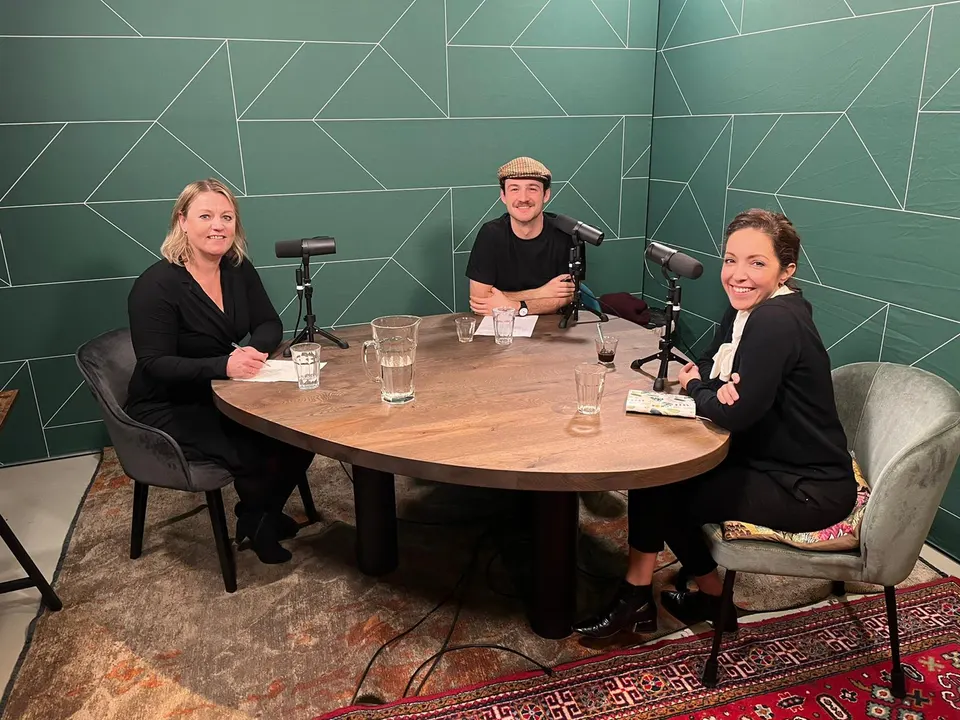 A podcast recording with three guests around a table
