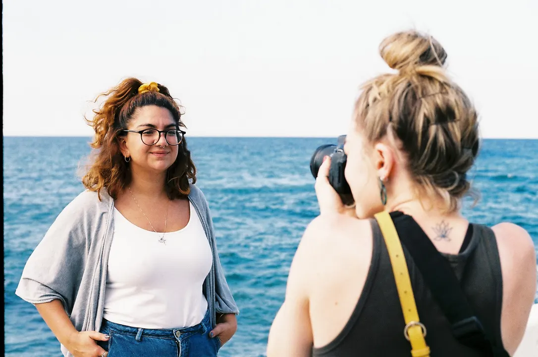 A photographer taking a portrait by the sea